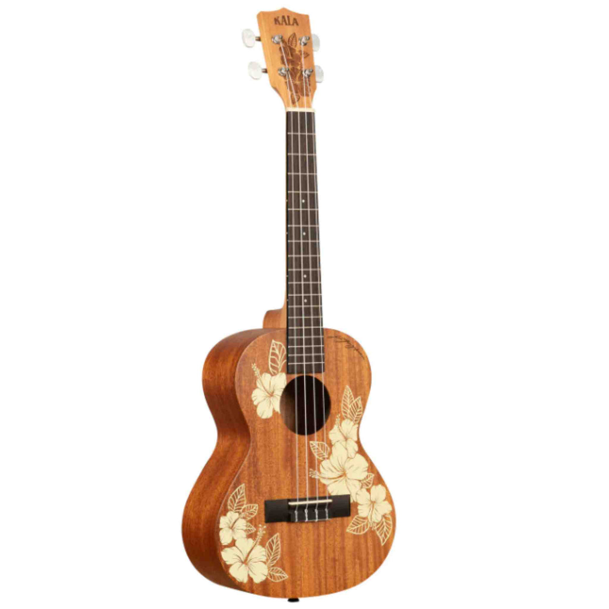 The image shows a beautiful Kala tenor or concert ukulele made of warm-toned wood, likely mahogany. It features laser-engraved hibiscus flower designs on the body, chrome tuning pegs, a dark wood fretboard with fret markers, a traditional bridge with a black saddle, and a round sound hole. This mid-to-high-end instrument showcases quality craftsmanship and a tropical Hawaiian aesthetic.
