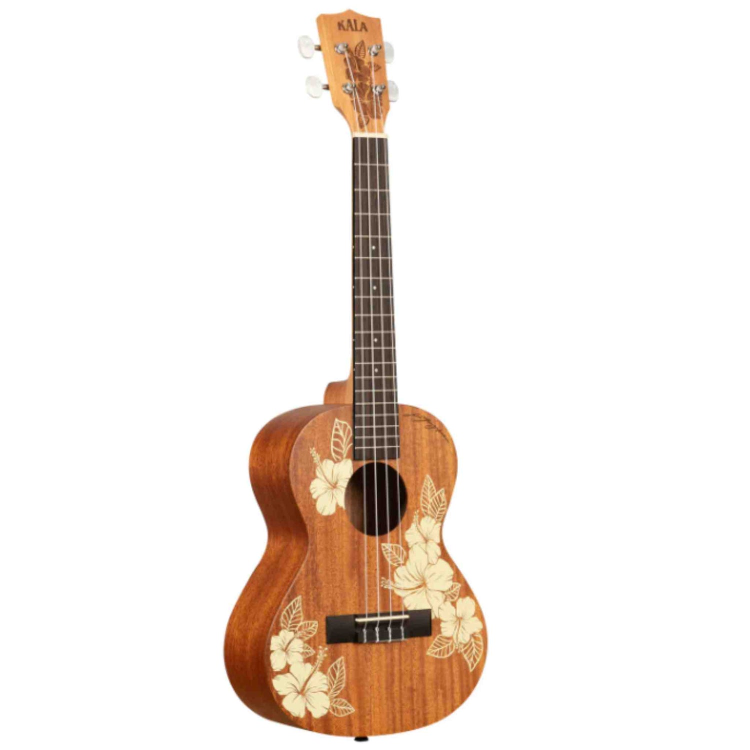The image shows a beautiful Kala tenor or concert ukulele made of warm-toned wood, likely mahogany. It features laser-engraved hibiscus flower designs on the body, chrome tuning pegs, a dark wood fretboard with fret markers, a traditional bridge with a black saddle, and a round sound hole. This mid-to-high-end instrument showcases quality craftsmanship and a tropical Hawaiian aesthetic.