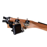 The image shows the headstock of a stringed instrument, likely a bass guitar or upright bass, made of light-colored wood with a natural finish. It features black tuning pegs with metal gears and a black clip-on tuner attached, a common accessory for accurately tuning by detecting string vibrations. The tuning hardware appears to be high-quality and professional.