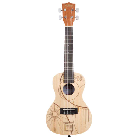 The image shows a beautiful ukulele with a light natural wood finish and four strings on a dark fretboard. It features chrome tuning pegs, a traditional body shape, and a sound hole. The body is decorated with engraved celestial designs, including sun and moon motifs, geometric patterns, and a "dixie pop" logo. The instrument combines artistic wood-burning with professional-quality construction for a unique, bohemian look.