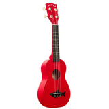 The image shows a bright red Makala ukulele with four strings and tuning pegs featuring cream-colored buttons. It has a dark fretboard, white binding around the edges, and a black fish-shaped design on the lower bout. This soprano or concert-sized instrument has a traditional body shape and is ideal for beginners seeking a vibrant, fun ukulele.