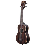The image shows a dark wood ukulele with four strings, chrome tuning pegs, a central sound hole, and frets along the neck. It has a visible brand logo on the headstock and exhibits a traditional design with rich wood grain. The instrument is photographed against a white background, highlighting its quality craftsmanship. Ukuleles are known for their bright, cheerful sound and are popular in Hawaiian and folk music.