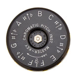 The black underside of the Kratt Chromatic pitch pipe with musical notation on a white background