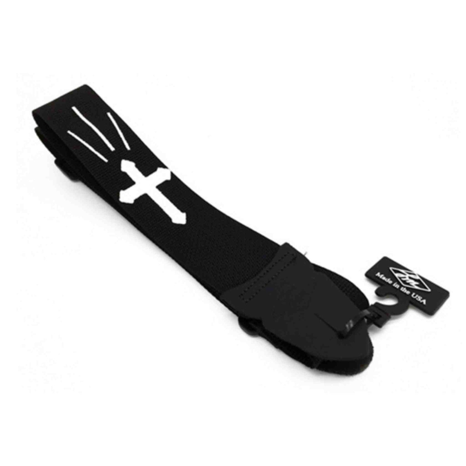 The image shows a black guitar strap made of durable fabric with white cross or plus sign designs. It features an adjustable length and a small black tag that reads "Made in the USA." This standard-width strap is designed to support electric and acoustic guitars, distributing the instrument’s weight across the shoulder. Its classic black and white design offers a versatile look suitable for various guitar styles.