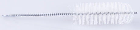 The image shows a long, thin cleaning brush for musical instruments, featuring a twisted wire shaft with white bristles at the tip arranged in a spiral pattern. It is designed to clean the interior of wind instruments like flutes, piccolos, clarinets, and oboes. The flexible wire allows it to reach curved sections, effectively removing moisture and debris to maintain instrument performance.