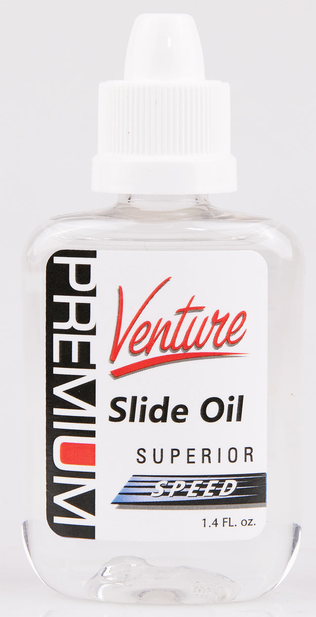 The image shows a clear plastic bottle of Venture Slide Oil by Premium, designed for brass instruments, especially trombones. It features a white dropper cap and black text with red and blue accents. The label highlights "Superior Speed" formula and the size of 1.4 FL. OZ. This slide oil lubricates trombone slides for smooth, fast movement, essential for optimal instrument performance.