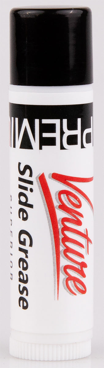 The image shows a bottle of LaVoce Slide Grease, a lubricant essential for brass instruments like trombones. It helps ensure smooth slide movement, improving playability and intonation. The white tube with a black cap is typical packaging for this maintenance product, commonly found in music stores alongside other brass instrument accessories.