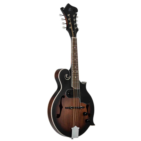 The image shows an F-style mandolin, a stringed instrument with a hollow wooden body, sunburst finish, and distinctive decorative scroll on the upper bout. It features 8 strings in 4 pairs, f-holes, a fretted neck with dot markers, an ornate headstock with tuning pegs, and pickup controls, indicating it is an acoustic-electric mandolin. This instrument is commonly used in bluegrass, folk, and classical music.
