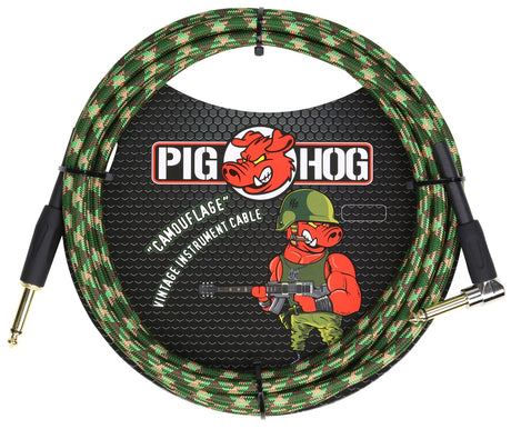 The image shows a Pig Hog "Camouflage" vintage guitar cable with a green, brown, and tan woven fabric jacket. It features the Pig Hog red pig logo and a military-themed cartoon pig in combat gear holding a guitar. The cable has professional 1/4" gold-plated connectors, with one straight and one right-angle plug, designed for electric guitars and basses.