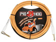 The image shows a Pig Hog "Orange Cream" 10-foot vintage instrument cable with orange and cream braided outer shielding. It features straight 1/4" connectors with gold-plated contacts and high-quality construction. Known for durability and retro design, this cable connects guitars or basses to amps or pedals, combining distinctive style with extra protection for internal wiring.