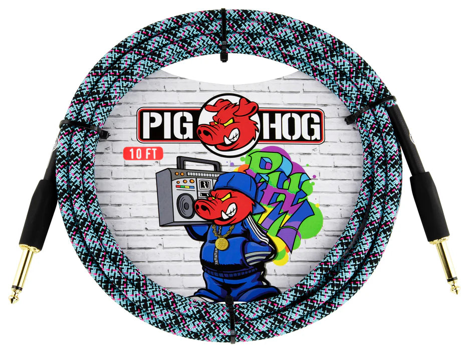 The image shows a 10-foot Pig Hog instrument cable with a colorful woven fabric jacket in black, teal, pink, and white zigzag pattern. It features gold-plated 1/4" straight connectors on both ends and Pig Hog branding with their pig mascot. The coiled cable is displayed against packaging with an urban street art design, highlighting its durable, tangle-resistant build for guitars, basses, and other instruments.