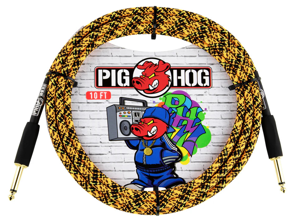 The image shows a 10-foot Pig Hog instrument cable with a yellow and black braided design for durability. It features 1/4" gold-plated phone plug connectors on both ends, suitable for electric guitars, basses, and keyboards. The packaging displays the Pig Hog logo with a pig mascot holding a boombox against a graffiti-style brick wall, highlighting the brand’s reputation for reliable, road-worthy cables.