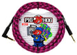The image shows a Pig Hog 10-foot guitar cable with a bright pink and black braided fabric exterior and gold-plated 1/4" connectors. The packaging features the Pig Hog logo with a red pig mascot and graffiti-style artwork of a pig with a boombox, reflecting an urban street art vibe. This durable, high-quality cable is designed for electric guitars and basses, combining bold style with reliable performance.