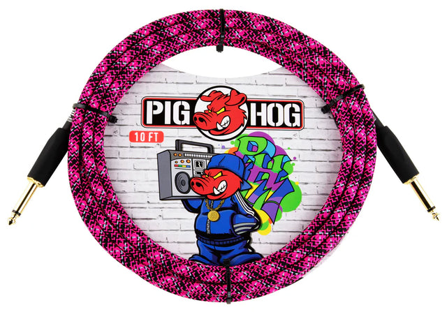 The image shows a 10-foot Pig Hog musical instrument cable with a bright pink and black braided exterior and gold-plated 1/4" TS connectors on both ends. The packaging displays the Pig Hog logo with a cartoon pig mascot against a brick wall. Known for colorful, durable cables, Pig Hog’s product is popular among guitarists and bassists for connecting instruments to amps or audio equipment.