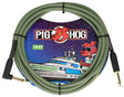 The image shows a Pig Hog 10-foot "Jamaican Green" vintage instrument cable with a green and black braided zigzag exterior and gold-plated 1/4" connectors—one straight and one right-angle. The packaging features the Pig Hog red pig mascot wearing sunglasses and a yacht illustration. This durable cable is designed for reliable signal transmission between guitars or instruments and amps or pedals.