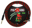 The image shows a 10-foot Pig Hog "Tartan Plaid" vintage-style instrument cable with a red and black plaid woven exterior and yellow stitching. It has standard 1/4" plugs (one straight, one right-angle) for connecting guitars or keyboards to amps or pedals. The Pig Hog branding with its red pig logo is visible on the packaging. The cable combines a classic look with durable protection for reliable signal transmission.