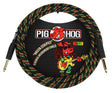 The image shows a Pig Hog 10-foot vintage instrument cable with a woven exterior featuring red, yellow, green, and black "Rasta Stripes." It has 1/4-inch gold-plated phone plugs on both ends for connecting guitars or basses to amps and audio gear. The packaging displays the Pig Hog logo with a red pig mascot playing guitar. The durable braided design offers protection and reduces tangling.