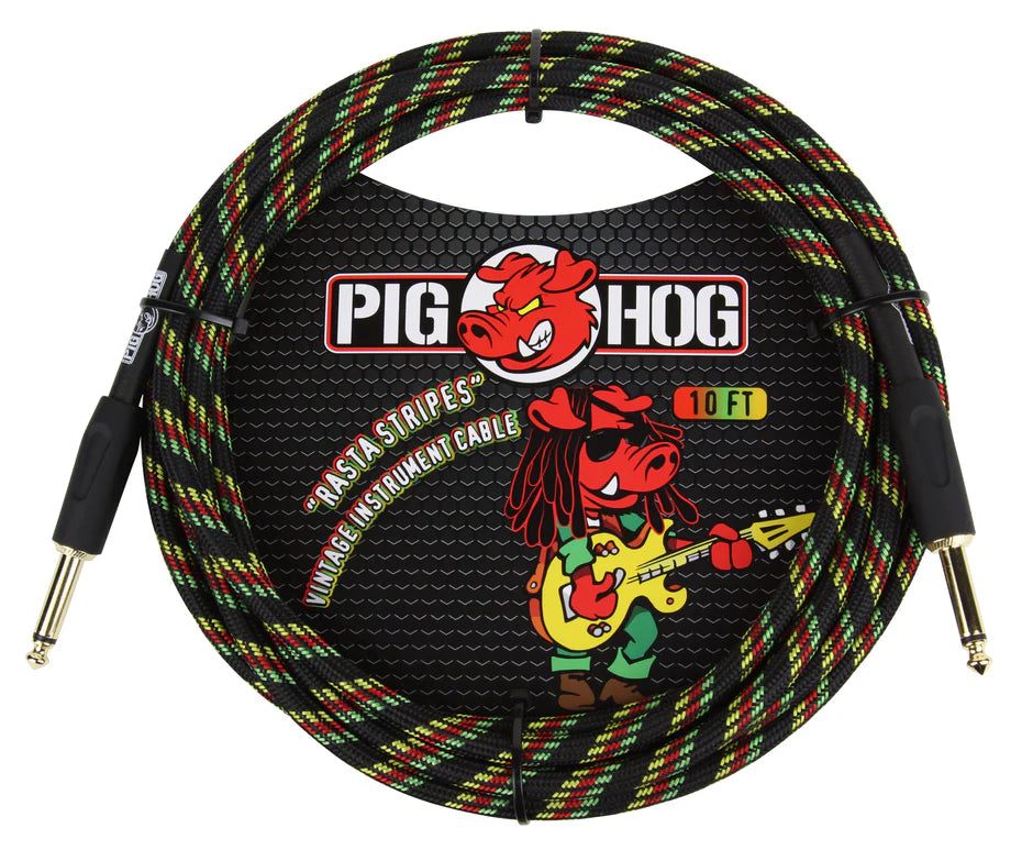 The image shows a Pig Hog 10-foot vintage instrument cable with a woven exterior featuring red, yellow, green, and black "Rasta Stripes." It has 1/4-inch gold-plated phone plugs on both ends for connecting guitars or basses to amps and audio gear. The packaging displays the Pig Hog logo with a red pig mascot playing guitar. The durable braided design offers protection and reduces tangling.