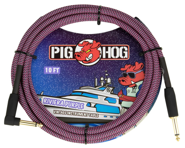 The image shows a Pig Hog 10-foot "Riviera Purple" vintage instrument cable with 1/4" gold-plated connectors on both ends. The cable has a purple and black woven zigzag fabric jacket for durability and style. The packaging features the Pig Hog logo with a red pig mascot wearing sunglasses against a starry background with a boat. This cable is used to connect guitars and other instruments to amps or pedals.