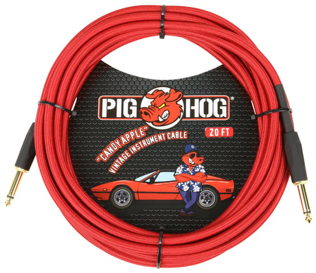 The image shows a Pig Hog "Candy Apple" 20-foot vintage-style instrument cable with a red braided exterior and gold-plated 1/4" TS plugs. The packaging features Pig Hog’s red pig mascot and retro design, including a vintage red sports car illustration. This cable connects electric guitars, basses, and other instruments to amplifiers and audio gear.
