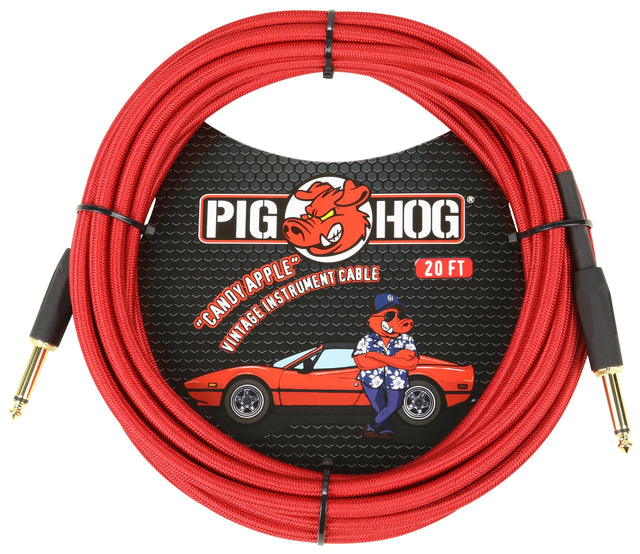 The image shows a Pig Hog "Candy Apple" 20-foot vintage-style instrument cable with a red braided exterior and gold-plated 1/4" TS plugs. The packaging features Pig Hog’s red pig mascot and retro design, including a vintage red sports car illustration. This cable connects electric guitars, basses, and other instruments to amplifiers and audio gear.
