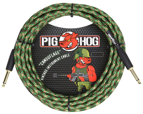The image shows a Pig Hog "Camouflage" vintage-style instrument cable about 20 feet long. It features a woven fabric exterior in green, brown, and tan camo, gold-plated 1/4" connectors, and professional-grade construction. The cable displays the Pig Hog branding with a cartoon pig mascot in military gear, combining a rugged tactical look with high-quality performance for connecting electric instruments to audio gear.
