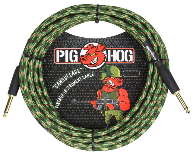 The image shows a Pig Hog "Camouflage" vintage-style instrument cable about 20 feet long. It features a woven fabric exterior in green, brown, and tan camo, gold-plated 1/4" connectors, and professional-grade construction. The cable displays the Pig Hog branding with a cartoon pig mascot in military gear, combining a rugged tactical look with high-quality performance for connecting electric instruments to audio gear.
