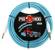 The image shows a Pig Hog "Daphne Blue" 20-foot vintage-style instrument cable with a light blue braided exterior, gold-plated 1/4" plugs, and the red pig mascot logo. It features black packaging decorated with a vintage car and pig graphic. Designed for electric guitars and other instruments, this durable, professional-grade cable combines reliable performance with distinctive, colorful styling.