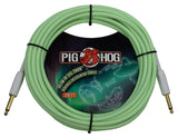 The image shows a 20-foot Pig Hog vintage instrument cable in seafoam green with gray housings. It features 1/4" straight plugs with gold-plated tips and a glow-in-the-dark design. Known for durability and low noise, this cable is ideal for guitars and basses. The distinctive color and glow feature help musicians locate it easily on dark stages, combining functionality with unique vintage style.