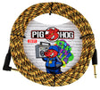 The image shows a Pig Hog 20-foot guitar instrument cable with a yellow and black woven fabric exterior. It has standard 1/4" plugs—one straight and one right-angle—used for connecting instruments to amps or pedals. The packaging features the Pig Hog logo with a red pig mascot and colorful graffiti-style artwork, highlighting the brand’s durable, tangle-resistant design and music-inspired aesthetic.
