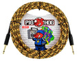 The image shows a coiled 20-foot Pig Hog instrument cable with a woven gold and black fabric exterior and gold-plated 1/4" connectors. The Pig Hog logo, featuring a pig mascot wearing headphones, is visible against a brick wall with graffiti-style art. Known for durability and low noise, this premium cable is favored by guitarists and bassists for reliable performance and extra protection.