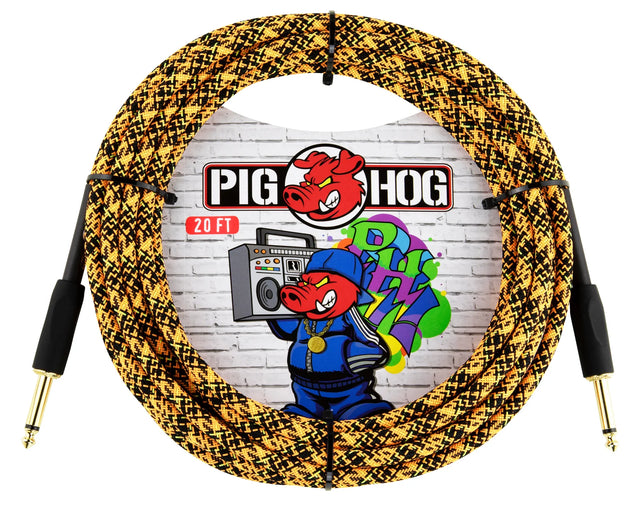 The image shows a coiled 20-foot Pig Hog instrument cable with a woven gold and black fabric exterior and gold-plated 1/4" connectors. The Pig Hog logo, featuring a pig mascot wearing headphones, is visible against a brick wall with graffiti-style art. Known for durability and low noise, this premium cable is favored by guitarists and bassists for reliable performance and extra protection.