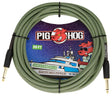 The image shows a 20-foot Pig Hog vintage instrument cable in "Jamaican Green," featuring a green and black woven chevron pattern. It has gold-plated 1/4" connectors on both ends and is coiled with packaging that depicts the pig mascot on a space-themed yacht. This premium, boutique-style cable is designed for connecting guitars, basses, and keyboards to amps or pedals, combining durability with distinctive visuals.
