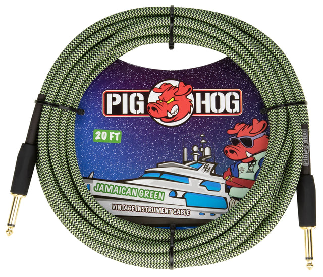 The image shows a 20-foot Pig Hog vintage instrument cable in "Jamaican Green," featuring a green and black woven chevron pattern. It has gold-plated 1/4" connectors on both ends and is coiled with packaging that depicts the pig mascot on a space-themed yacht. This premium, boutique-style cable is designed for connecting guitars, basses, and keyboards to amps or pedals, combining durability with distinctive visuals.