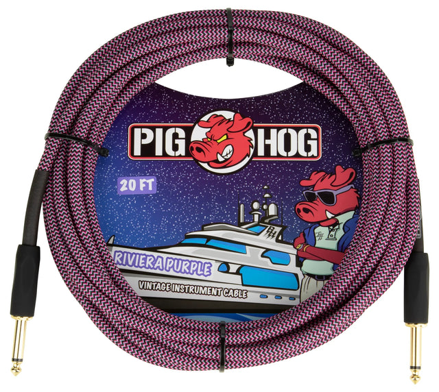 The image shows a Pig Hog "Riviera Purple" 20-foot vintage instrument cable with a purple and black braided exterior. It has gold-plated 1/4" connectors on both ends for guitars, basses, and other instruments. The packaging features the Pig Hog logo with a cartoon pig mascot wearing sunglasses and a nautical theme. Pig Hog cables are known for durability, stylish design, and reliability among musicians.