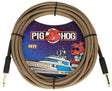 The image shows a Pig Hog "Tuscan Brown" vintage 20-foot instrument cable with a woven brown braided exterior and gold-plated 1/4" plugs. The packaging features the Pig Hog logo with a red pig mascot wearing sunglasses and nautical-themed artwork. This durable, high-quality cable connects guitars, basses, or instruments to amps, pedals, or interfaces, combining vintage style with reliable performance.