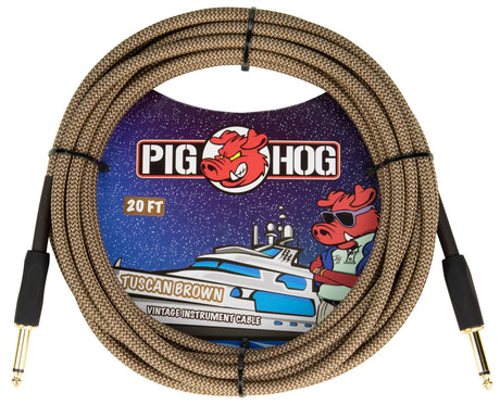 The image shows a Pig Hog "Tuscan Brown" vintage 20-foot instrument cable with a woven brown braided exterior and gold-plated 1/4" plugs. The packaging features the Pig Hog logo with a red pig mascot wearing sunglasses and nautical-themed artwork. This durable, high-quality cable connects guitars, basses, or instruments to amps, pedals, or interfaces, combining vintage style with reliable performance.