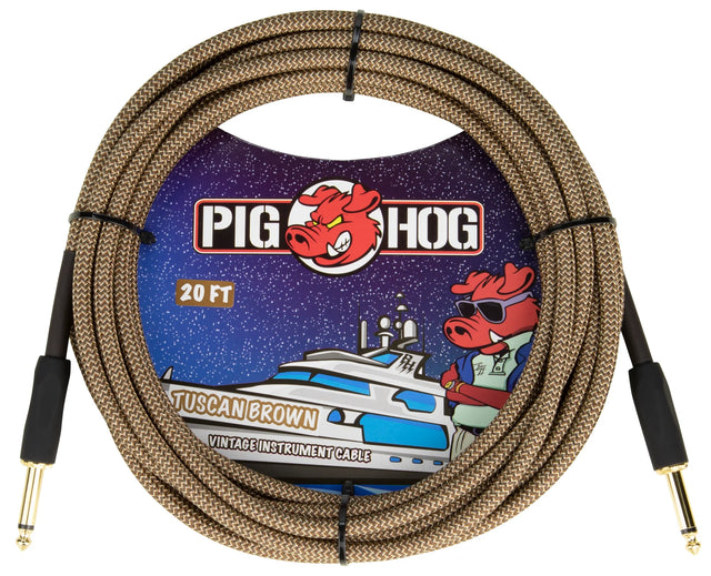The image shows a Pig Hog "Tuscan Brown" vintage 20-foot instrument cable with a woven brown braided exterior and gold-plated 1/4" plugs. The packaging features the Pig Hog logo with a red pig mascot wearing sunglasses and nautical-themed artwork. This durable, high-quality cable connects guitars, basses, or instruments to amps, pedals, or interfaces, combining vintage style with reliable performance.