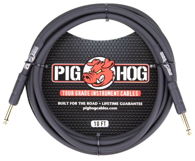 The image shows a Pig Hog Tour Grade 10-foot instrument cable with gold-plated 1/4" TS connectors and a coiled black/dark gray cable. It features the red pig mascot logo, "Built for the road," "Lifetime guarantee," and pighogcables.com on the packaging. This professional cable is designed for electric guitars, basses, and other instruments, offering durable, reliable connections ideal for live performance and frequent use.