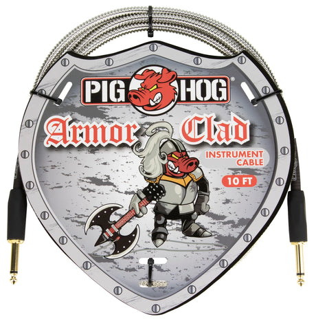The image shows a Pig Hog "Armor Clad" 10-foot instrument cable featuring gold-plated 1/4" TS connectors and heavy-duty braided metal shielding for durability. It displays the Pig Hog red pig mascot logo and comes in shield-shaped packaging with a medieval knight holding a battle axe. This professional-grade cable is designed for electric guitars, basses, and other instruments, emphasizing rugged construction and reliable signal protection.