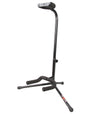 The image shows a black, adjustable guitar stand with a tripod base for stability. It has a height adjustment collar on the vertical pole and a padded yoke at the top to safely cradle the guitar's body. Protective padding prevents scratches or damage. This stand is commonly used by guitarists to securely hold guitars during play, practice, or storage, keeping the instrument accessible and safe from falls.