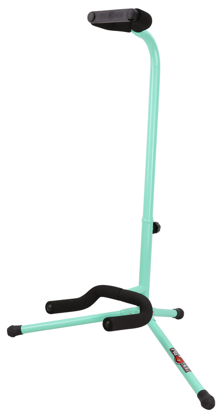 The image shows a tripod-style guitar stand with a mint green tubular metal frame and black padded cushioning on the neck rest and base. It has a collapsible tripod base for stability and an adjustable height mechanism on the vertical post. The brand name "Guitar Stand" is visible on the neck rest. This stand is designed to safely hold acoustic or electric guitars, offering both protection and an attractive alternative to standard black stands.