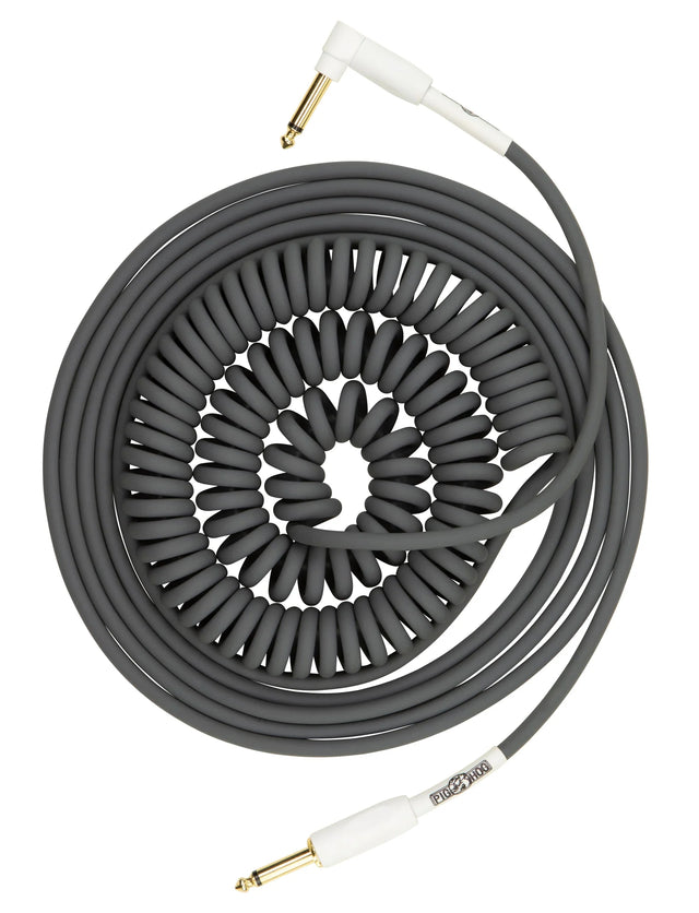 The image shows a coiled instrument cable with gold-plated 1/4" TS connectors and white housings. Its dark gray/black spiral design stretches and retracts, preventing tangles and allowing freedom of movement. Popular among guitarists and bassists, it connects electric instruments to amps or pedals, offering a classic vintage look favored in rock and blues.