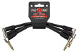 The image shows a set of Pig Hog "Lil' Pigs" 6-inch patch cables with black sheathing and gold-colored right-angled 1/4-inch connectors. These short cables connect guitar effects pedals on a pedalboard, helping musicians chain multiple effects neatly. Known for their durable, professional-grade build, Pig Hog cables are ideal for live and studio use, offering reliable performance in compact pedal setups.