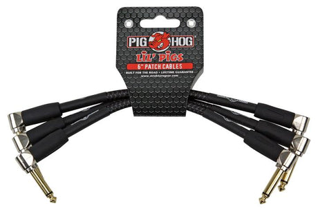 The image shows a set of Pig Hog "Lil' Pigs" 6-inch patch cables with black sheathing and gold-colored right-angled 1/4-inch connectors. These short cables connect guitar effects pedals on a pedalboard, helping musicians chain multiple effects neatly. Known for their durable, professional-grade build, Pig Hog cables are ideal for live and studio use, offering reliable performance in compact pedal setups.