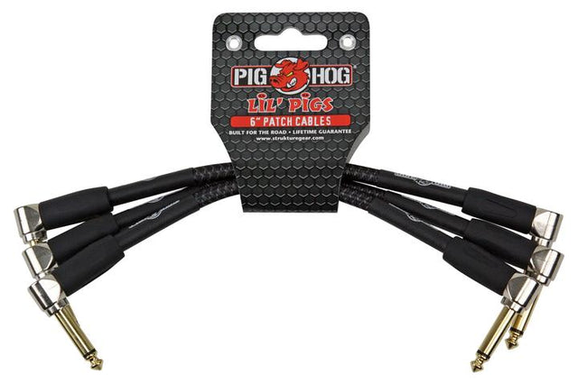 The image shows a set of Pig Hog "Lil' Pigs" 6-inch patch cables with black sheathing and gold-colored right-angled 1/4-inch connectors. These short cables connect guitar effects pedals on a pedalboard, helping musicians chain multiple effects neatly. Known for their durable, professional-grade build, Pig Hog cables are ideal for live and studio use, offering reliable performance in compact pedal setups.
