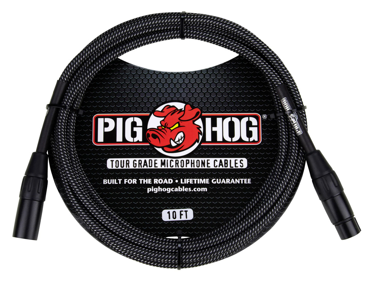 The image shows a Pig Hog Tour Grade 10-foot microphone cable with XLR male to female connectors. It features a black woven outer sleeve, the red Pig Hog pig mascot logo, and branding that highlights "Built for the Road" and a lifetime guarantee. This professional-grade cable is designed for durable, reliable use by touring musicians and audio professionals.