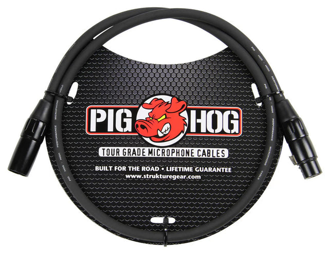 The image shows a Pig Hog Tour Grade microphone cable by Strukture Gear, featuring the red pig mascot logo. It has professional XLR male to female connectors and a black cable. Labeled "Built for the Road" with a lifetime guarantee, this durable cable is designed for professional use in live sound, recording, and studio settings.