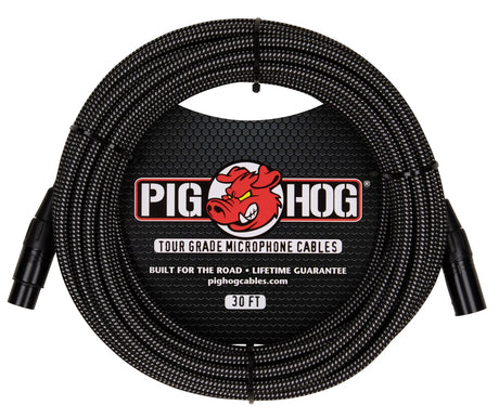 The image shows a Pig Hog Tour Grade 30-foot microphone cable with a black braided exterior, featuring XLR connectors on both ends. It includes the Pig Hog red pig logo and advertises "Built for the Road" and a lifetime guarantee. Designed for professional audio use, the cable is durable and ideal for touring musicians connecting microphones to audio equipment. The brand’s website, pighogcables.com, is also displayed.