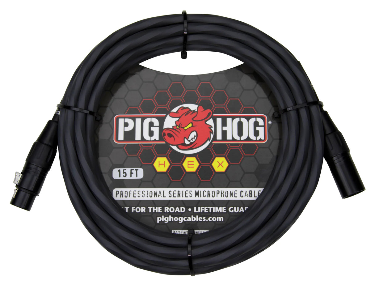 The image shows a coiled 15-foot Pig Hog Professional Series XLR microphone cable with male and female connectors. It features a black cable with the Pig Hog red pig logo, yellow "HEX" series lettering, and marketing tags "Built for the Road" and "Lifetime Guarantee." This durable cable is designed for professional audio use in music production and live sound.